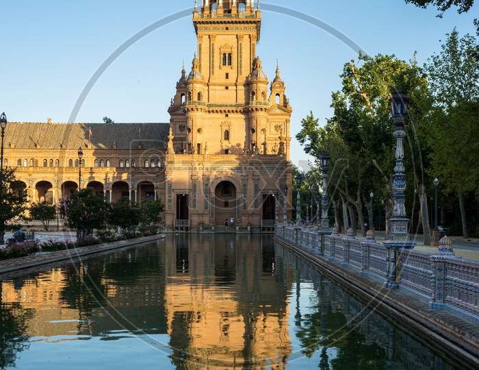 Spain, Seville, Reflection Of Building In Water At Plaza De Espana