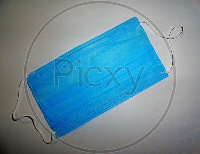 Blue color surgical mask on gray background