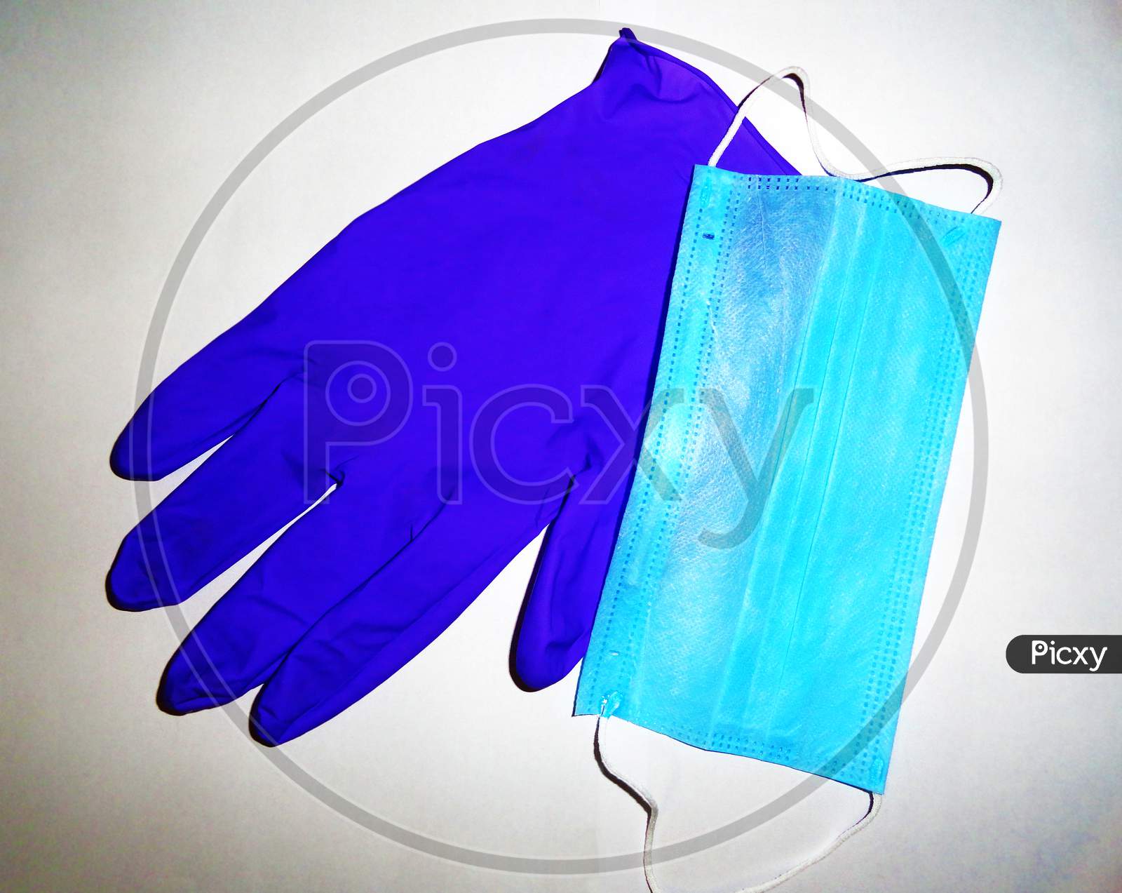 Blue color disposable surgical mask and glove on white background