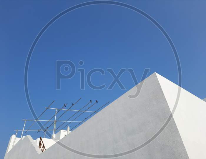 morning view of blue sky and white building at roof of house