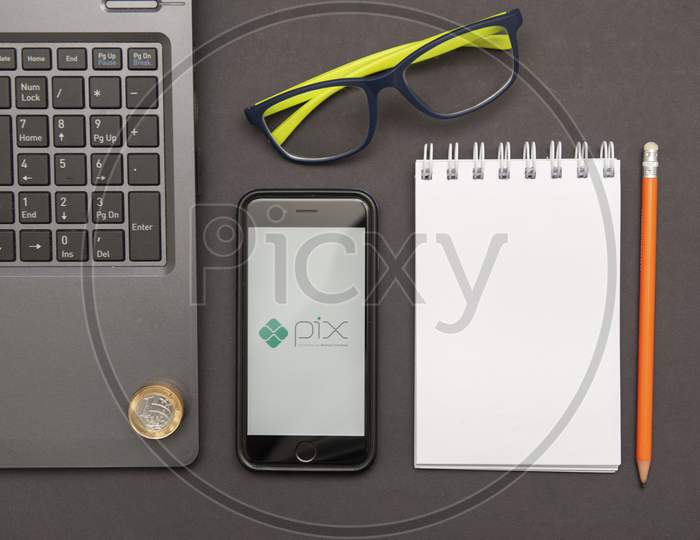 Florianopolis, Brazil. 28/09/2020: Top View Of Pix Logo On Smartphone Screen, Notepad Glasses And Notebook On The Black Table. Pix, New Brazilian Electronic Payment System. Brazilian Central Bank.