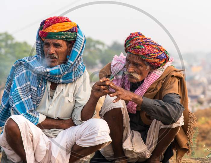 Two camel herders sharing a smoke