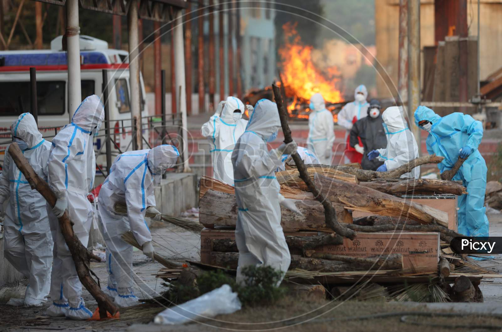 Relatives and health workers wearing protective suits cremate the  bodies of COVID-19 victims, at Jammu District,on 30 September,2020.