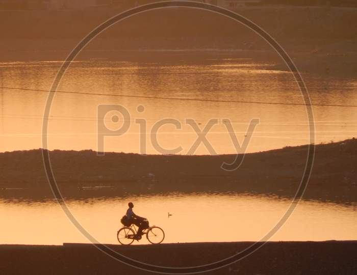 Silhouette Man Riding Bicycle