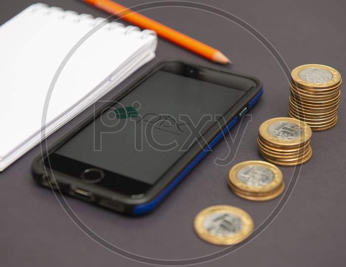 Florianopolis, Brazil. 28/09/2020: Top View Of Pix Logo On Smartphone Screen Next To Growing Piles Of Coins. Pix Is ​​A New And Faster Brazilian Money Transfer System - Central Bank. Selective Focus.
