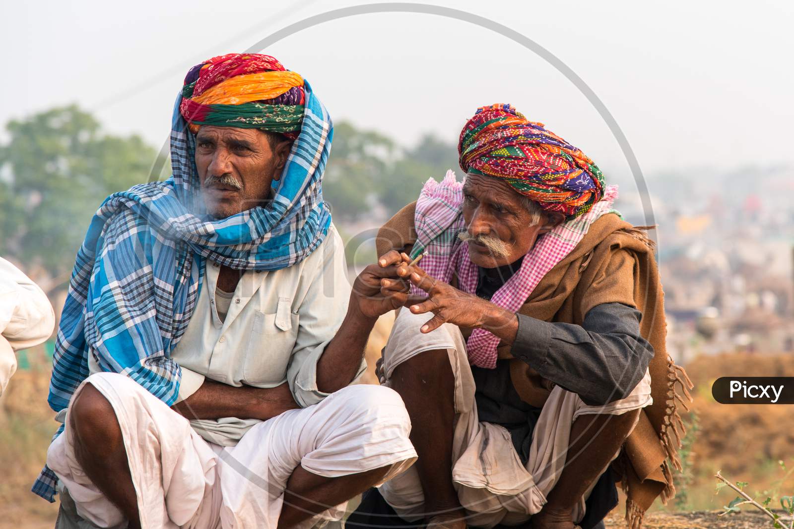 Two camel herders sharing a smoke