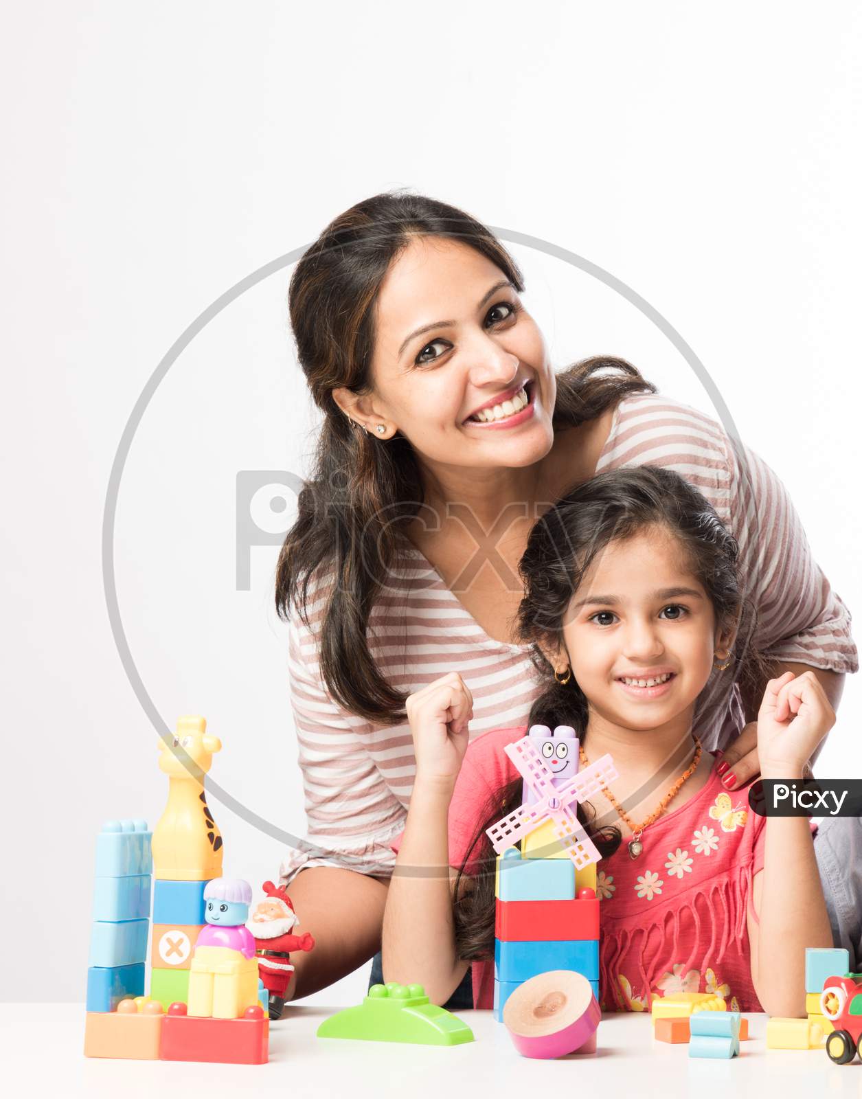 Cute Little Indian Kids Playing Colourful Block Toys With Parents At Home