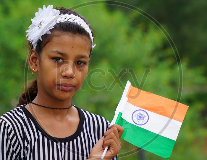 20 September 2020 : Reengus, Jaipur, India / Cute Indian Girl Standing On Roof Holding National Indian Flag.