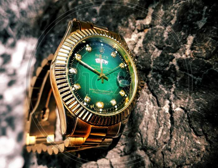 Golden Watch With Green Dial on Wood