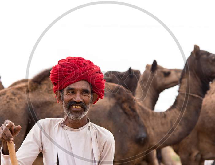 A smiling camel herder