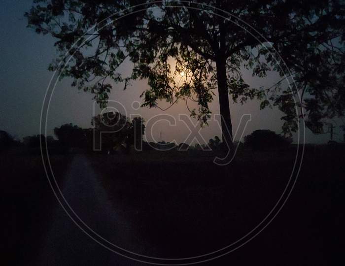 Night photography of moon in village