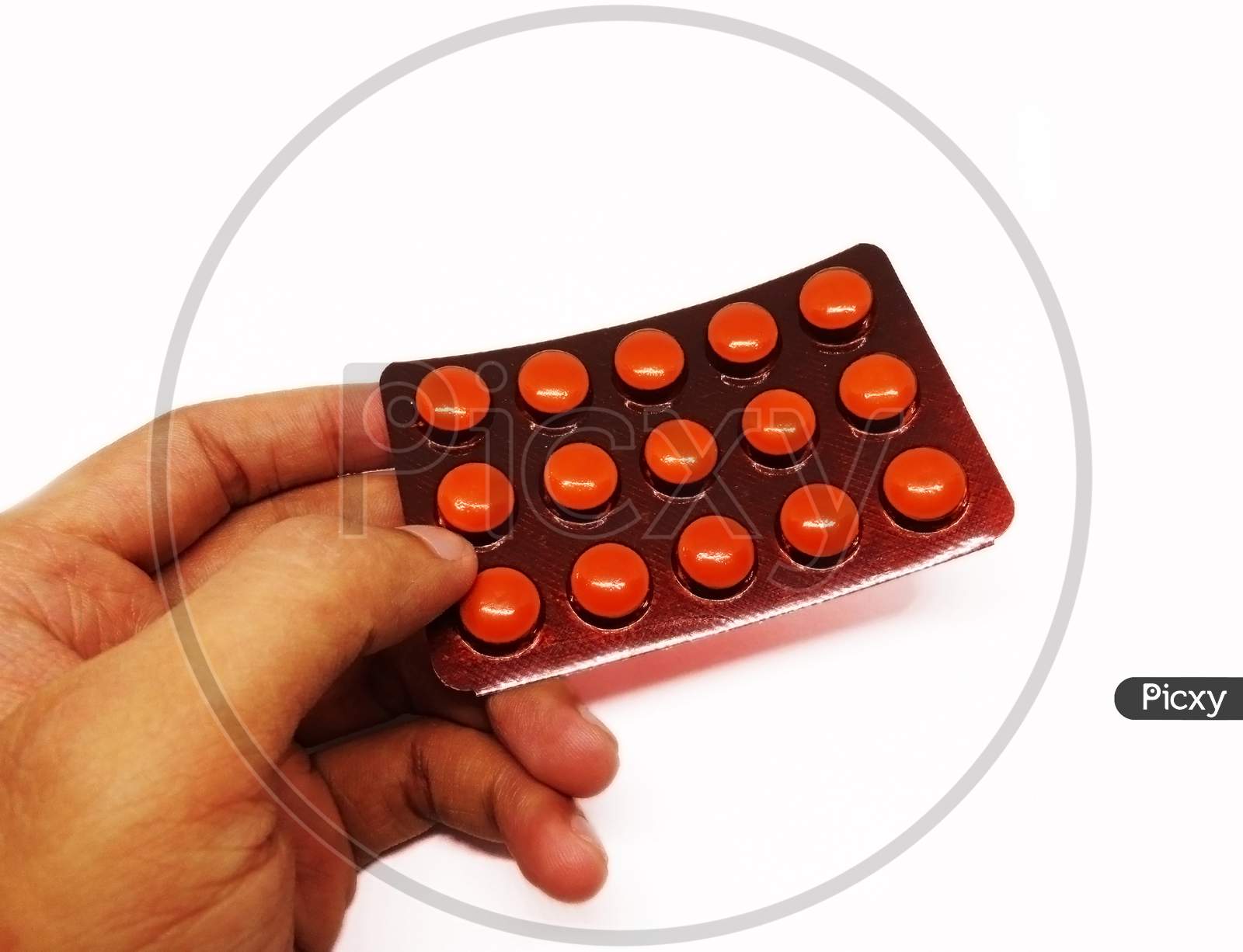 Pharmaceutical pills hold in hand on white background