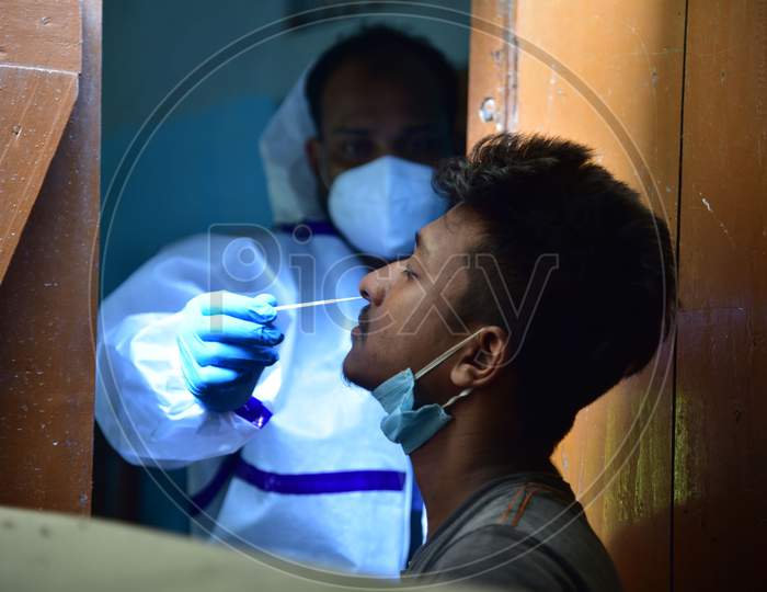 A health worker takes samples for COVID-19 Rapid Antigen Tests, in Nagaon district, in the northeastern state of Assam on Sept 30,2020.