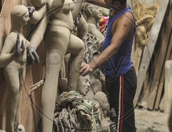 An artist busy making Durga