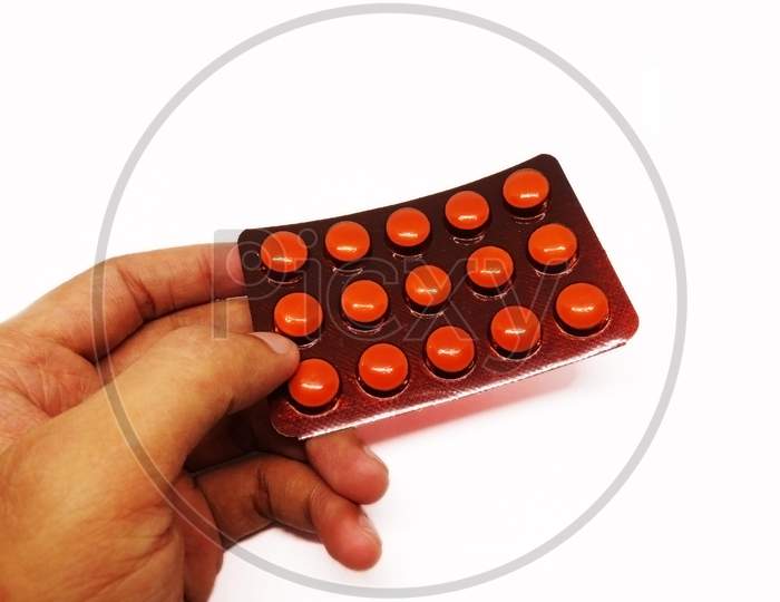 Pharmaceutical pills hold in hand on white background