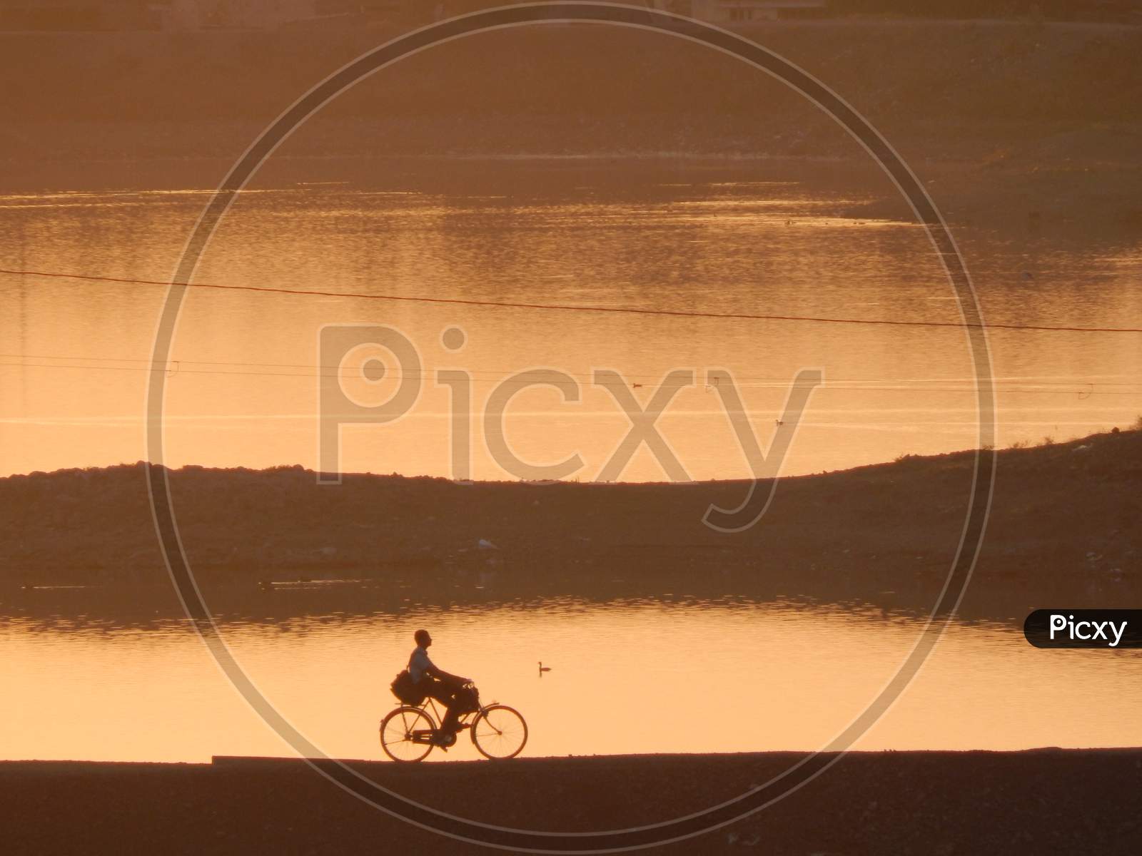 Silhouette Man Riding Bicycle