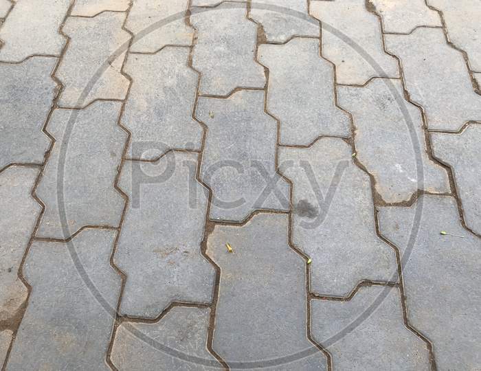 Grey Color Interlocking Tiles Pattern Background Tiles In The Streets In Which Sand Grouting