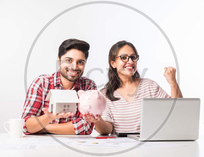 Indian couple accounting with laptop