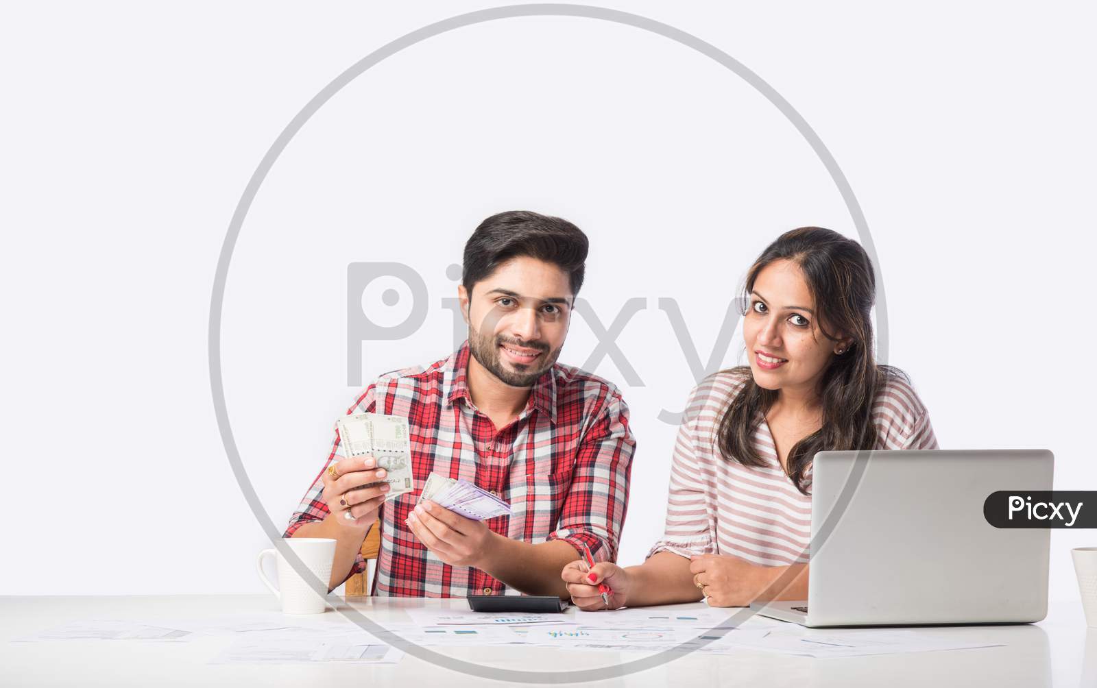 Indian couple accounting with laptop