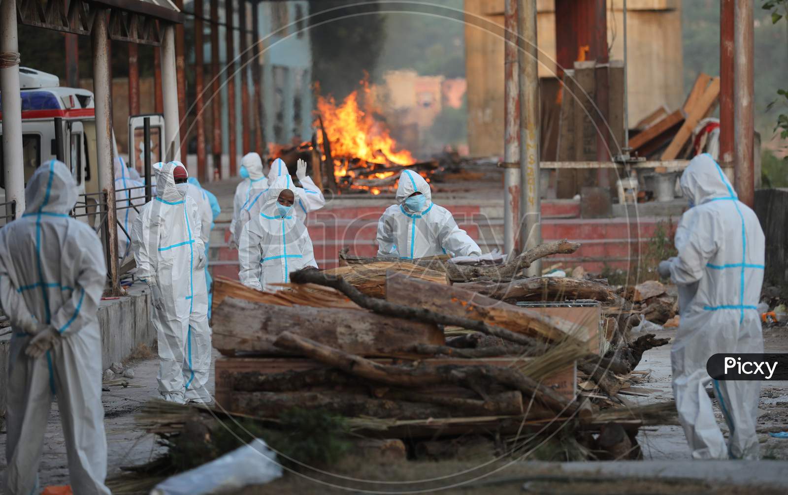 Relatives and health workers wearing protective suits cremate the  bodies of COVID-19 victims, at Jammu District,on 30 September,2020.