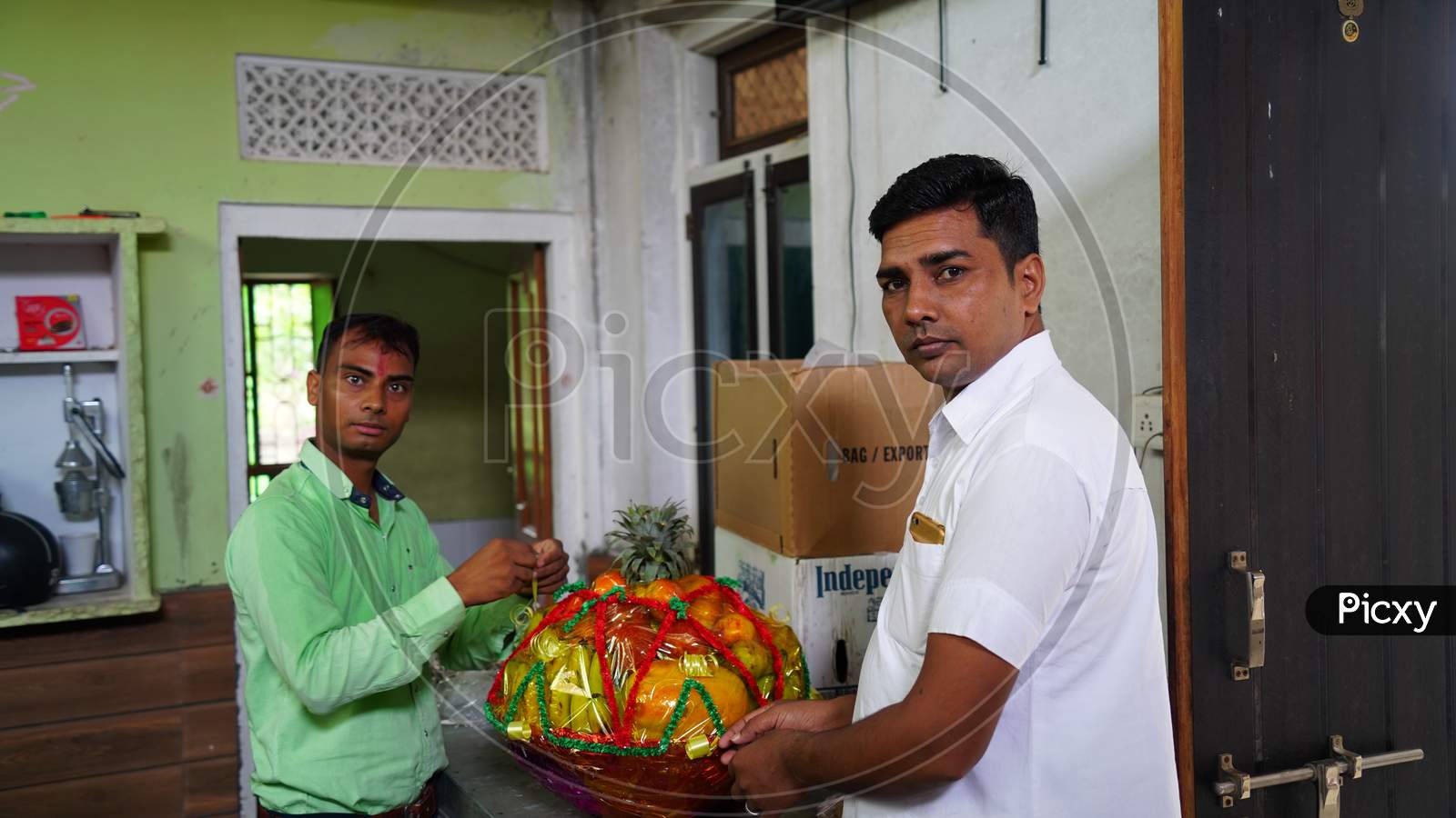 20 September 2020 : Reengus, Jaipur, India / Two Male Movers Wrapping The Home Appliances With Plastic Wrap On Home Background