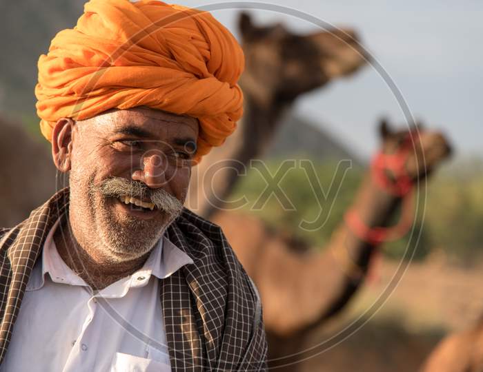 Candid portrait of a smiling camel herder