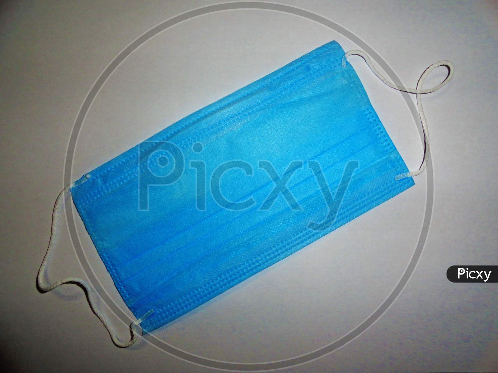Blue color surgical mask on gray background