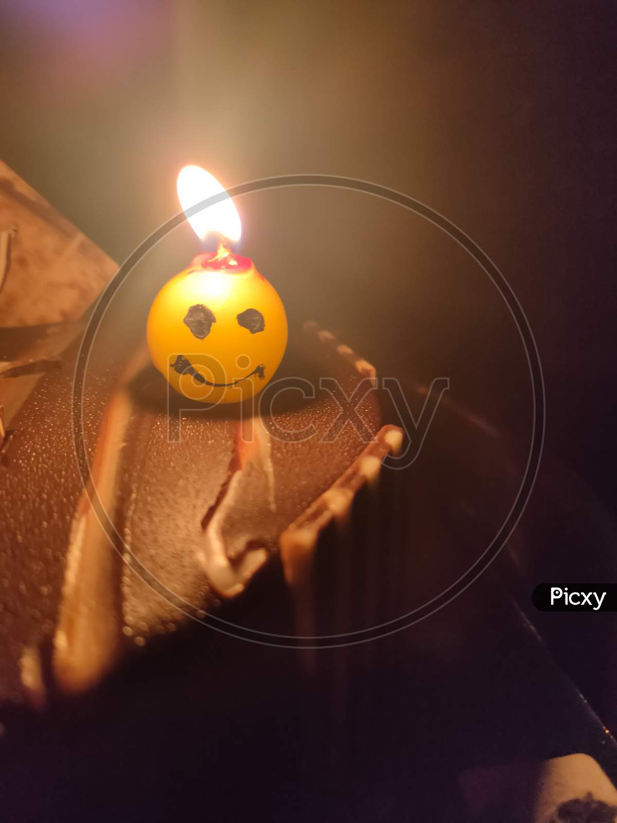 Candle On Birthday Cake Selective Focus And Blur Image