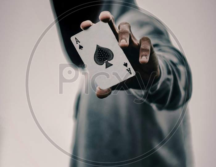 Man holding card of ace