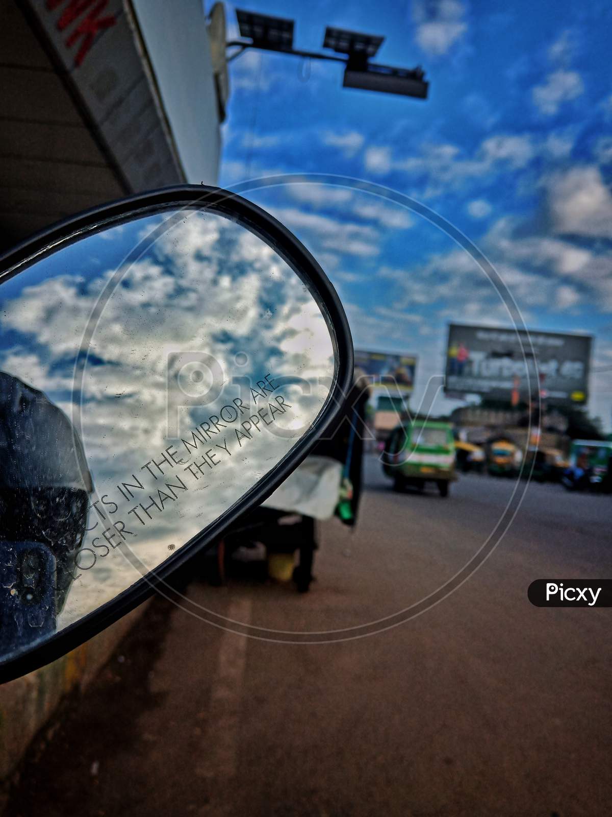 view of sky through a mirror, street photography, clouds