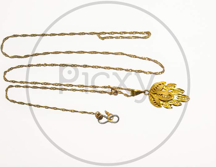 Gold chain and gold pendant isolated on white background