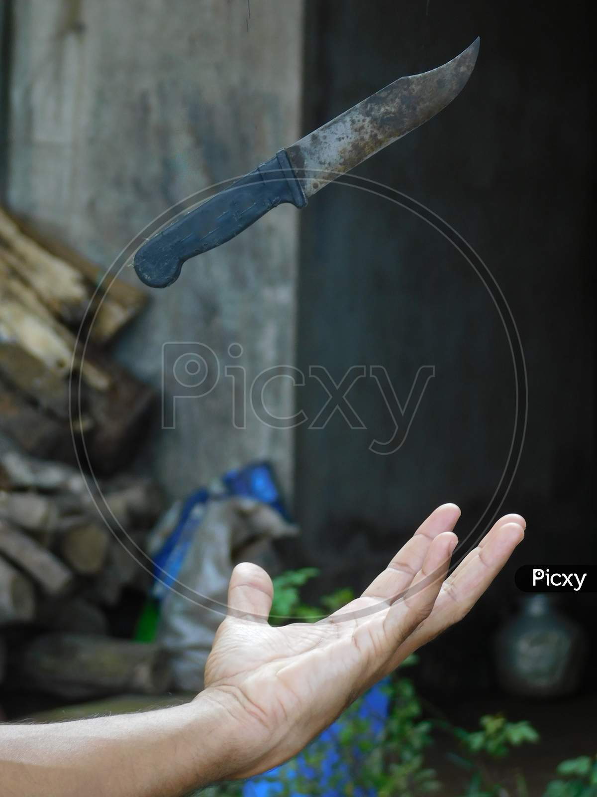 Hand trying to catch a falling knife