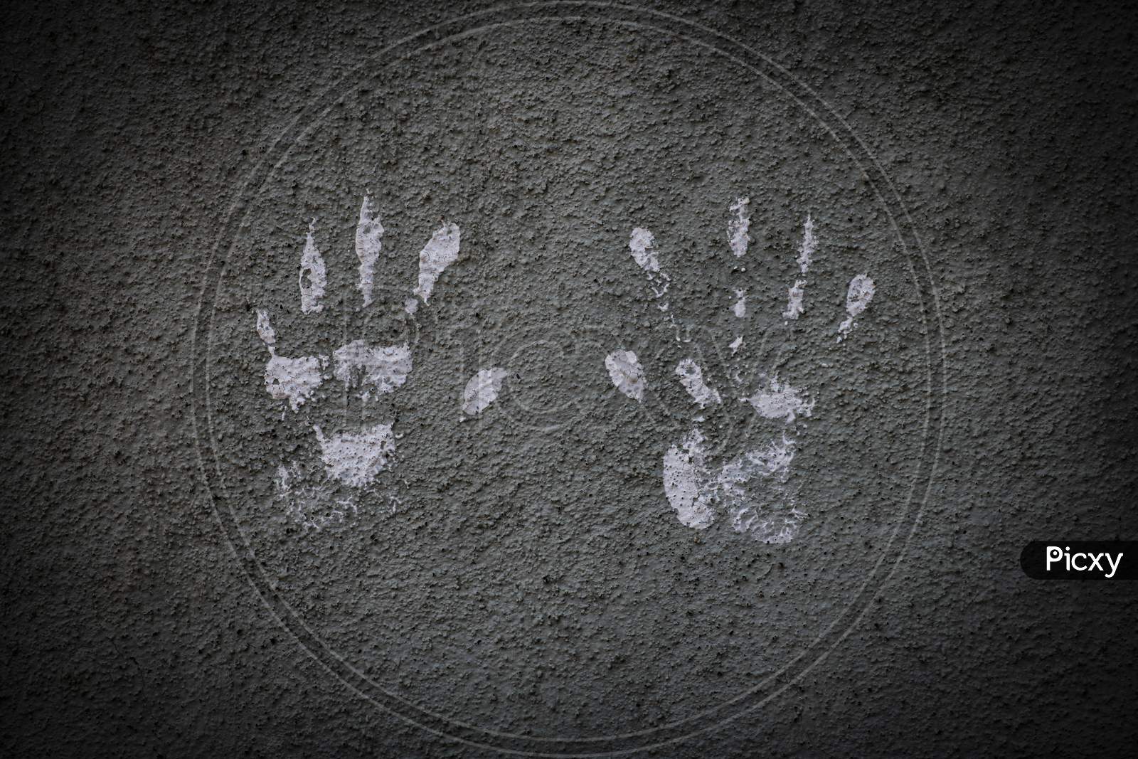 White Hand Prints On A Cement Wall