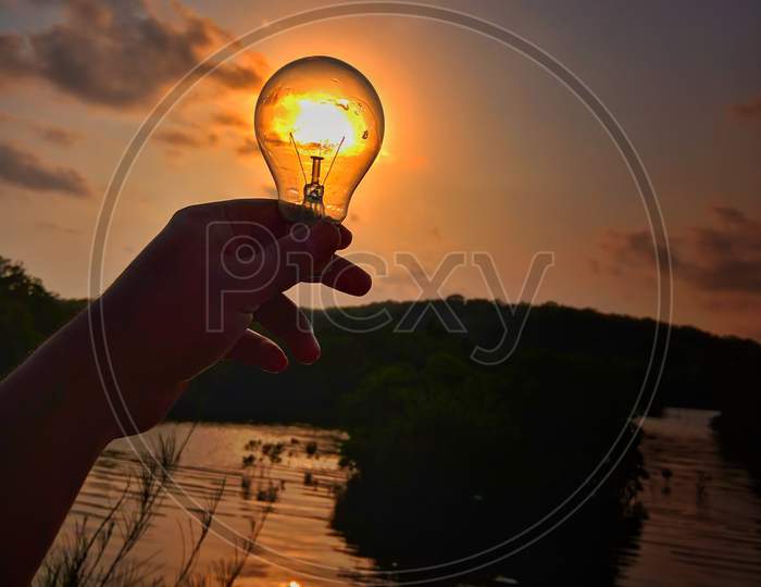 Sunlight holds in bulb on the bank of river