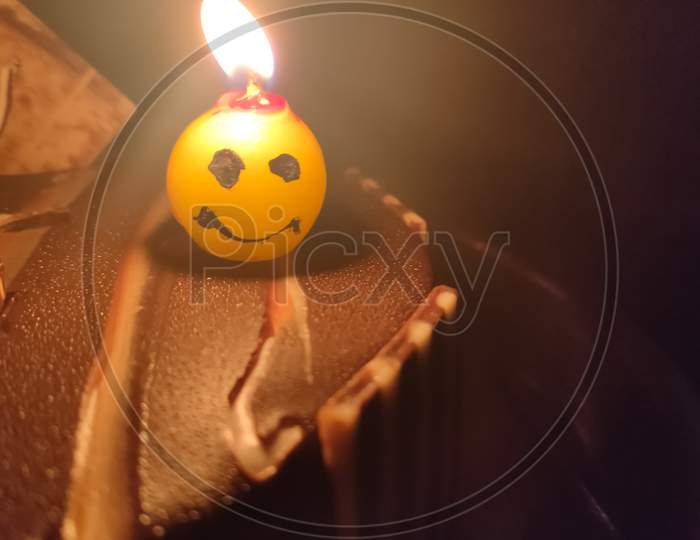 Candle On Birthday Cake Selective Focus And Blur Image