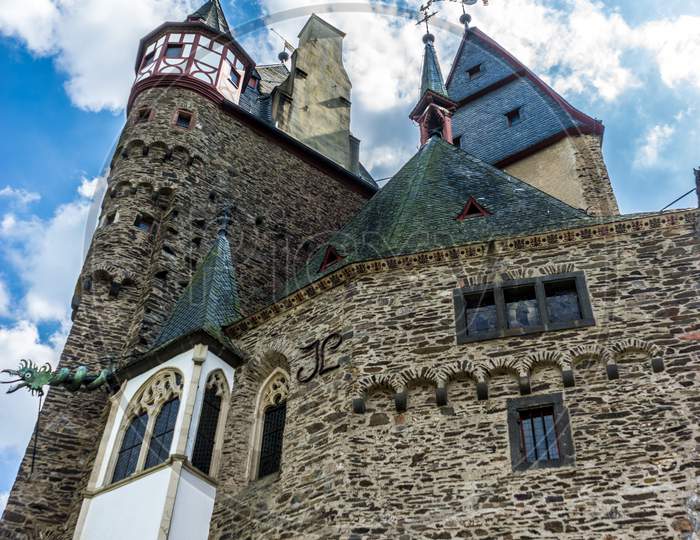 Germany, Burg Eltz Castle, A Castle With A Clock At The Top Of A Building