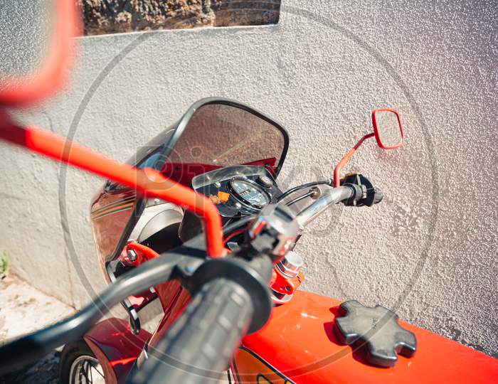 Close Up Of A Vintage Red Motorbike During A Sunny Day