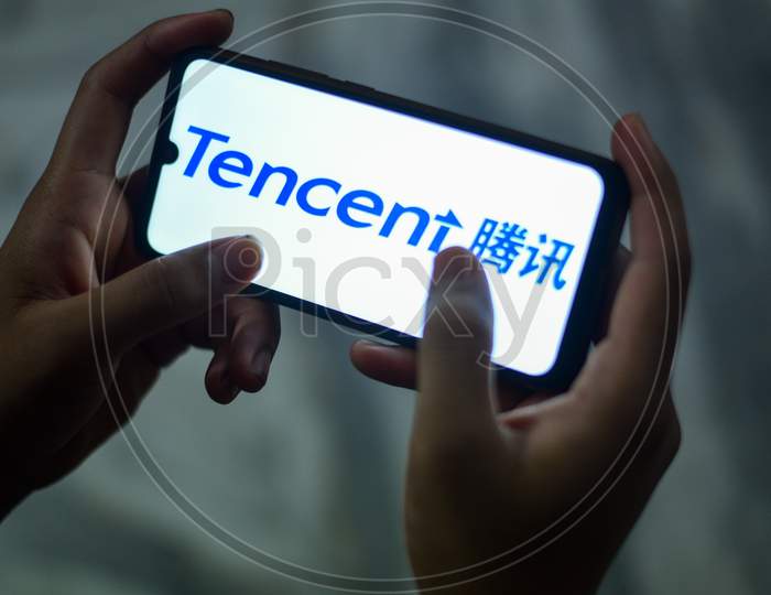 a man downloading an app related to Tencent Holdings Ltd.
