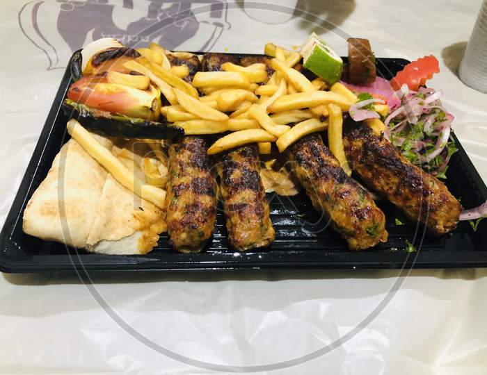Grilled kebab with fries photography