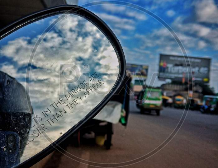 view of sky through a mirror, street photography, clouds