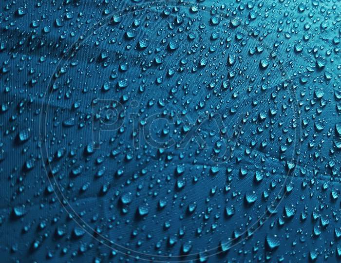 Water droplets on a blue Umbrella- Wallpaper