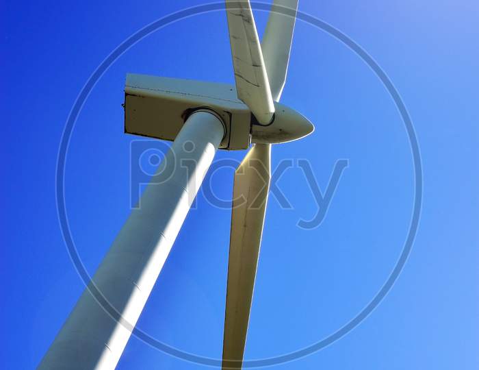 White Wind power storage turbine against blue sky