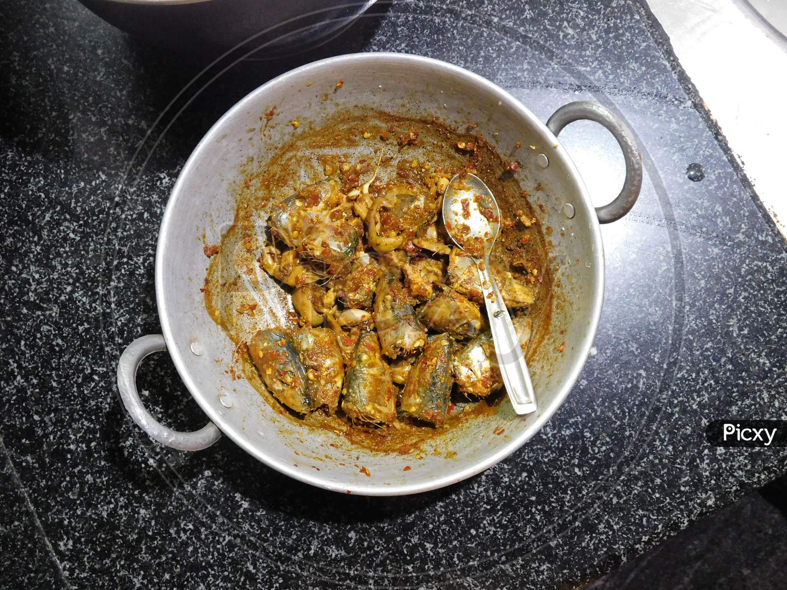 delicious Kerala style fish curry is served in a bowl