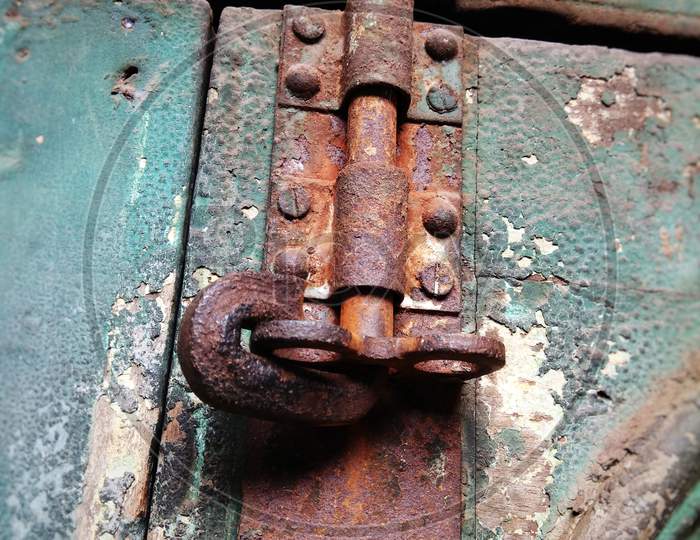 Rusty iron door lock on a old wooden door
