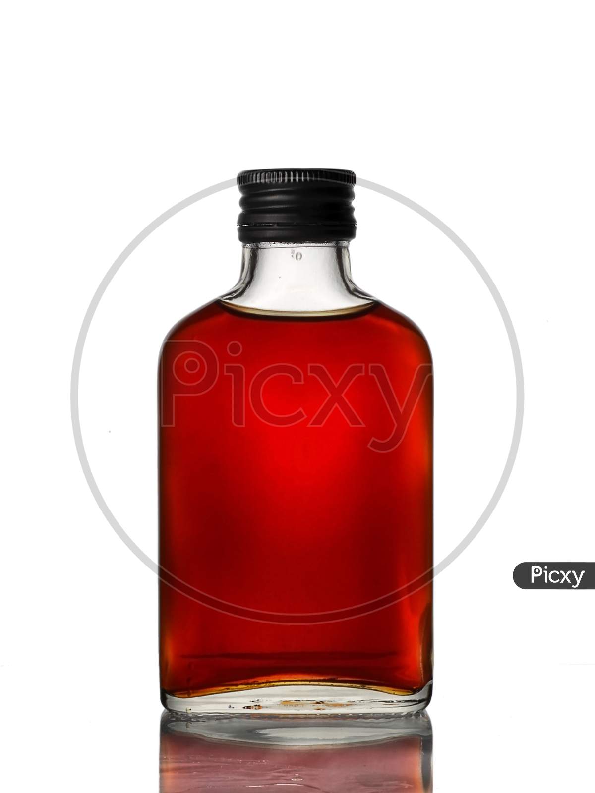 Mini glass bottle with brown beverage