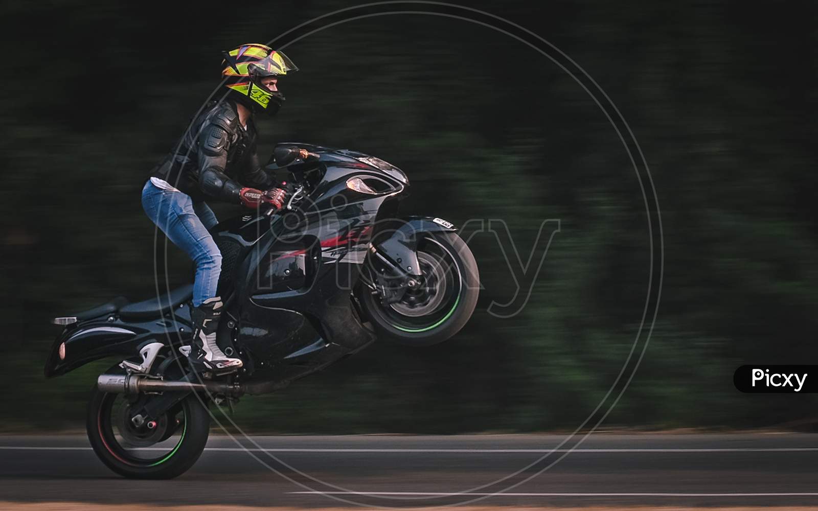 motorcycle rider doing wheelie on a Superbike