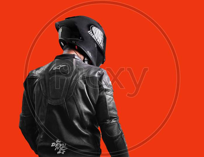 motorcycle rider with helmet in black riding gears
