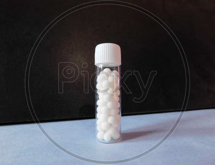 A homeopathic medicine bottle isolated on a surface