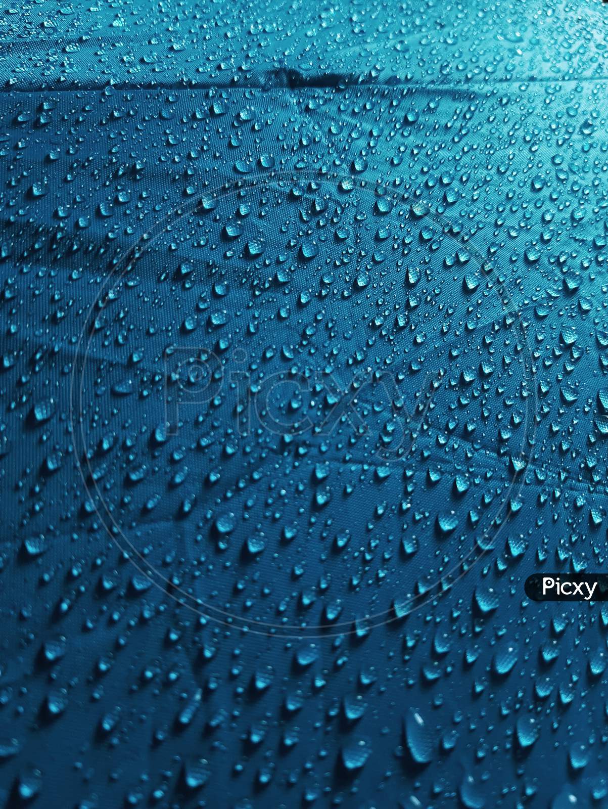 Water droplets on a blue Umbrella- Wallpaper