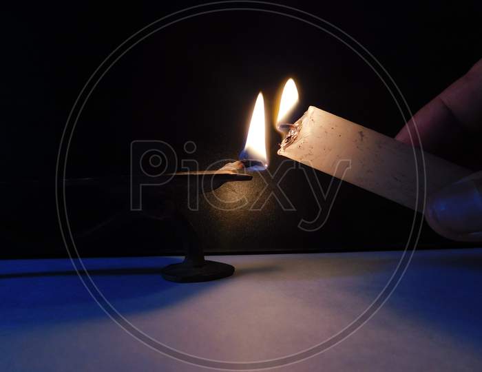 Light from the lamp and light from the candle on the dark background